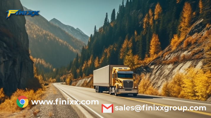 A yellow truck driving through a scenic autumn mountain road, showcasing durable Finixx truck tires designed for challenging terrains